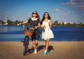 Two beautiful girls on the beach with bicycle Royalty Free Stock Photo