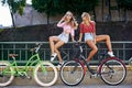 Two beautiful girls on a bicycles outdoor summer portrait. Royalty Free Stock Photo