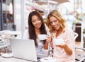 Two beautiful girls in cafe with laptop Royalty Free Stock Photo