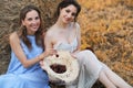 Two girls in dresses in autumn field Royalty Free Stock Photo