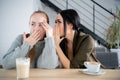 Two beautiful girls gossiping in a cafe bar Royalty Free Stock Photo