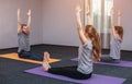 Two beautiful girls and man do yoga in the sport center and spa. Royalty Free Stock Photo