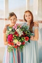 Two beautiful girls wearing occasional dresses