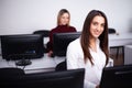 Two beautiful girls work in the office of a consulting company Royalty Free Stock Photo