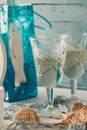 Two beautiful glasses of white wine with marine decoration on a white wooden table Royalty Free Stock Photo