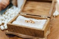 Two beautiful golden bridal rings lying in a wooden box