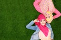 Two beautiful happy muslim woman smiling lying on grass with cop