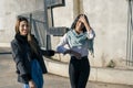 Two beautiful happy smiling women walking through an urban setting. Joy concept Royalty Free Stock Photo