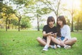 Two beautiful happy young asian women friends having fun together at park and taking a selfie. Royalty Free Stock Photo