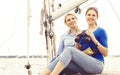 Two beautiful, attractive young girls with binocular on a yacht. Royalty Free Stock Photo