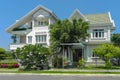 Two beautiful houses with trees, and landscape design in the summer.