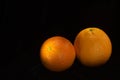 Two Beautiful Juicy Oranges on Black Velvet Royalty Free Stock Photo