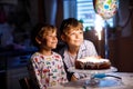 Two beautiful kids, little preschool boys celebrating birthday and blowing candles Royalty Free Stock Photo