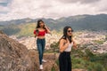 Two beautiful Latina teens on vacation touring a mountain
