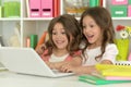 Two cute little girls at class with laptop Royalty Free Stock Photo