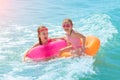 Two beautiful little girls play and have fun in sea water on the beach. Vacation or holiday concept. Children girls with Royalty Free Stock Photo