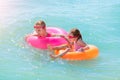 Two beautiful little girls play and have fun in sea water on the beach. Vacation or holiday concept. Children girls with Royalty Free Stock Photo