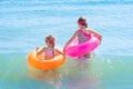 Two beautiful little girls play and have fun in sea water on the beach. Vacation or holiday concept. Children girls with Royalty Free Stock Photo