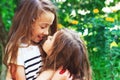 Two beautiful little girls smiling and playing at the garden Royalty Free Stock Photo