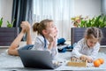 Two beautiful little sisters playing chess on a floor in living room Royalty Free Stock Photo