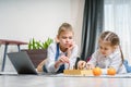 Two beautiful little sisters playing chess on a floor in living room Royalty Free Stock Photo