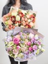 Two beautiful luxury bouquet of mixed flowers in woman hand. the work of the florist at a flower shop. A small family Royalty Free Stock Photo