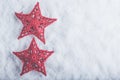 Two Beautiful magical vintage red stars on a white snow background. Winter and Christmas concept Royalty Free Stock Photo