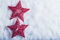 Two Beautiful magical vintage red stars on a white snow background. Winter and Christmas concept Royalty Free Stock Photo