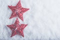 Two Beautiful magical vintage red stars on a white snow background. Winter and Christmas concept Royalty Free Stock Photo