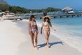 Two beautiful mixed rase women at the beach