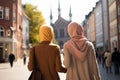 Two beautiful Muslim women wearing hijabs in European city on sunny day