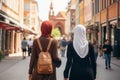 Two beautiful Muslim women wearing hijabs in European city on sunny day