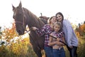 Three adult woman outdoors with horse child