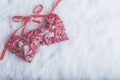 Two beautiful romantic vintage red hearts tied together with ribbon on white snow background. Love and St. Valentines Day concept Royalty Free Stock Photo