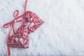 Two beautiful romantic vintage red hearts tied together with ribbon on white snow background. Love and St. Valentines Day concept Royalty Free Stock Photo