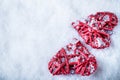 Two beautiful romantic vintage red hearts together on white snow winter background. Love and St. Valentines Day concept Royalty Free Stock Photo