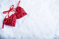 Two beautiful romantic vintage red hearts together on white snow winter background. Love and St. Valentines Day concept Royalty Free Stock Photo