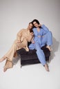 Two beautiful sexy woman friends wear casual clothes home beige and blue suit comfortable organic fashion model natural makeup