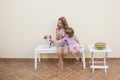 Two beautiful sister kids eating a watermelon ice cream with their cute dog. Family love and lifestyle outdoors