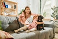 Two beautiful sistres, little girls, children playing, hugging purebred dog, brown labrador at home. Having fun Royalty Free Stock Photo