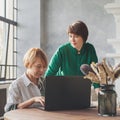 Two beautiful smart mature business women working laptop computer