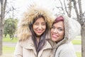 Two beautiful smiling woman friends in the park. Royalty Free Stock Photo