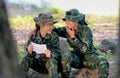 Two beautiful soldier women look happy and enjoy with reading letters from someone Royalty Free Stock Photo