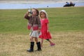 Two beautiful stylish little girls are walking in the St.James`s Park