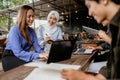 two beautiful university students chat while working on an assignment Royalty Free Stock Photo