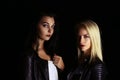 Two beautiful vampires girls wearing a leather jacket