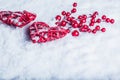 Two beautiful vintage red hearts with mistletoe berries on a white snow background. Christmas, love and St. Valentines Day concept Royalty Free Stock Photo