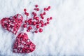 Two beautiful vintage red hearts with mistletoe berries on a white snow background. Christmas, love and St. Valentines Day concept Royalty Free Stock Photo