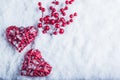 Two beautiful vintage red hearts with mistletoe berries on a white snow background. Christmas, love and St. Valentines Day concept Royalty Free Stock Photo