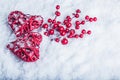 Two beautiful vintage red hearts with mistletoe berries on a white snow background. Christmas, love and St. Valentines Day concept Royalty Free Stock Photo